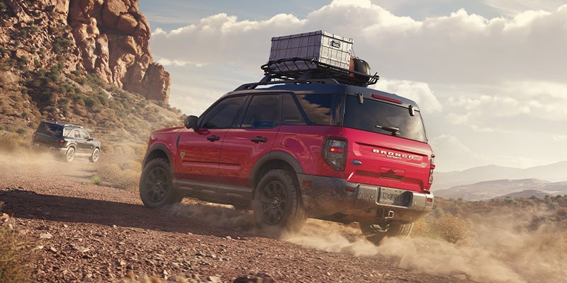 A red 2025 Ford Bronco Sport driving in the desert.